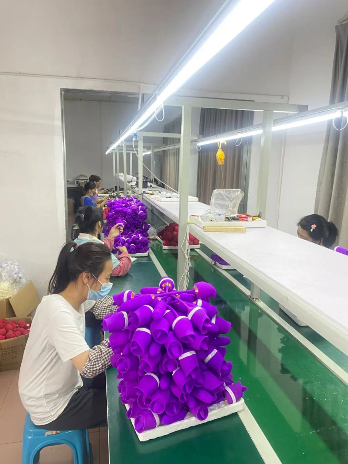 Workers assembling purple products in supplier media